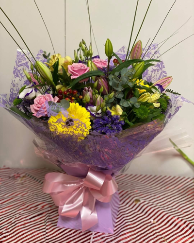 Colourful Wishes - A vibrant bouquet bursting with cheerful pink, yellow, purple and green tones for a bright and uplifting display.