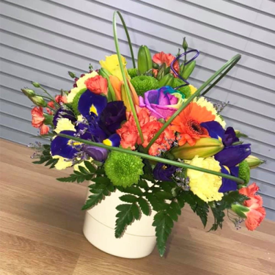 Colour Burst - A bold contemporary arrangement in vibrant orange, purple, yellow and green tones, designed for a bright and eye-catching finish.